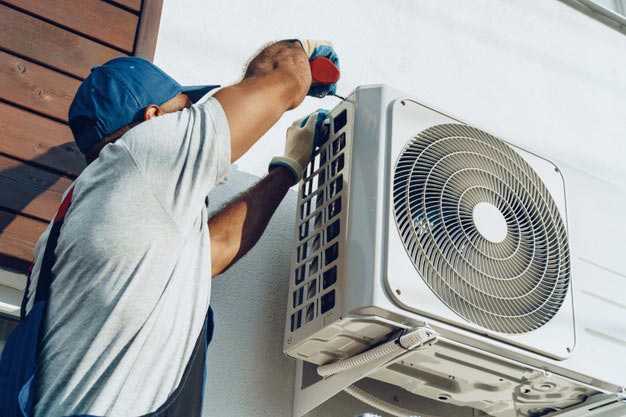 Technician is repairing AC Repair Services Mirdif